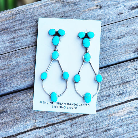 7 stone Kingman turquoise earrings with a tear drop shape. approximately 2.75 inches in length 