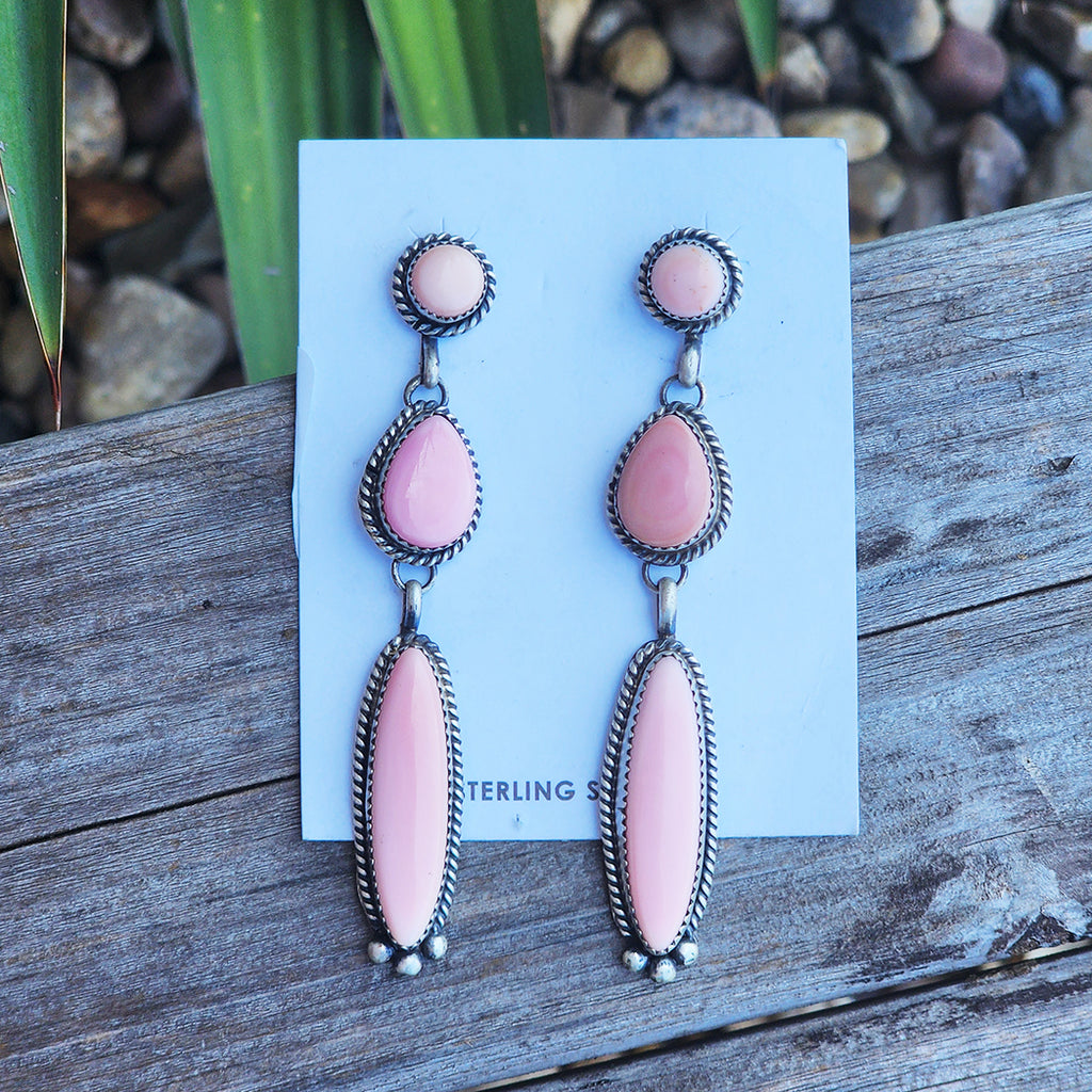 beautifully crafted Native American earrings featuring three pink conch stones