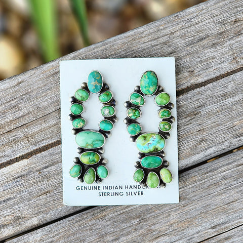 These  are a statement pair of earrings, 12 stones of sonoran gold turquoise set in a very unique shape 