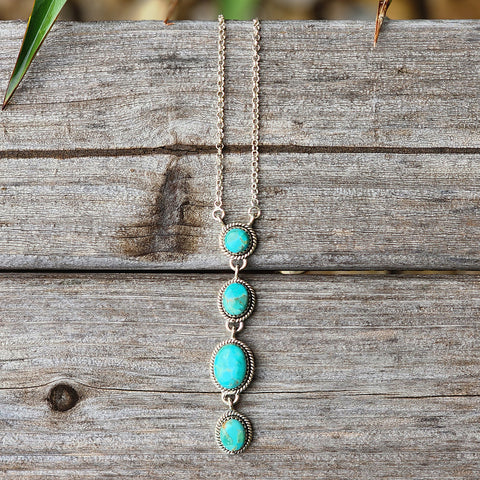4 stone turquoise necklace. The 4 stones are circles and 3 inches in length