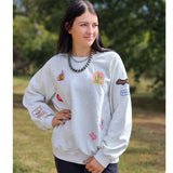 light grey sweatshirt with fun western mismatched patches all over the sweatshirt