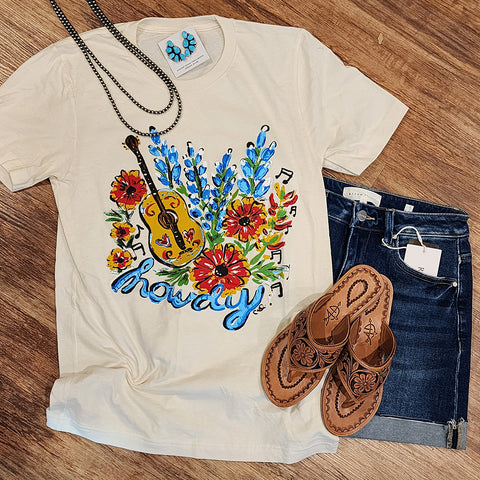 cream tee features charming blue bonnets and a playful "howdy" for a touch of whimsy