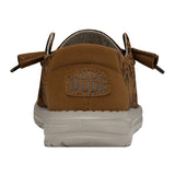 A backside angle of a HEYDUDE shoe. The back is primarily brown, with a patch that contains HEYDUDE's logo.