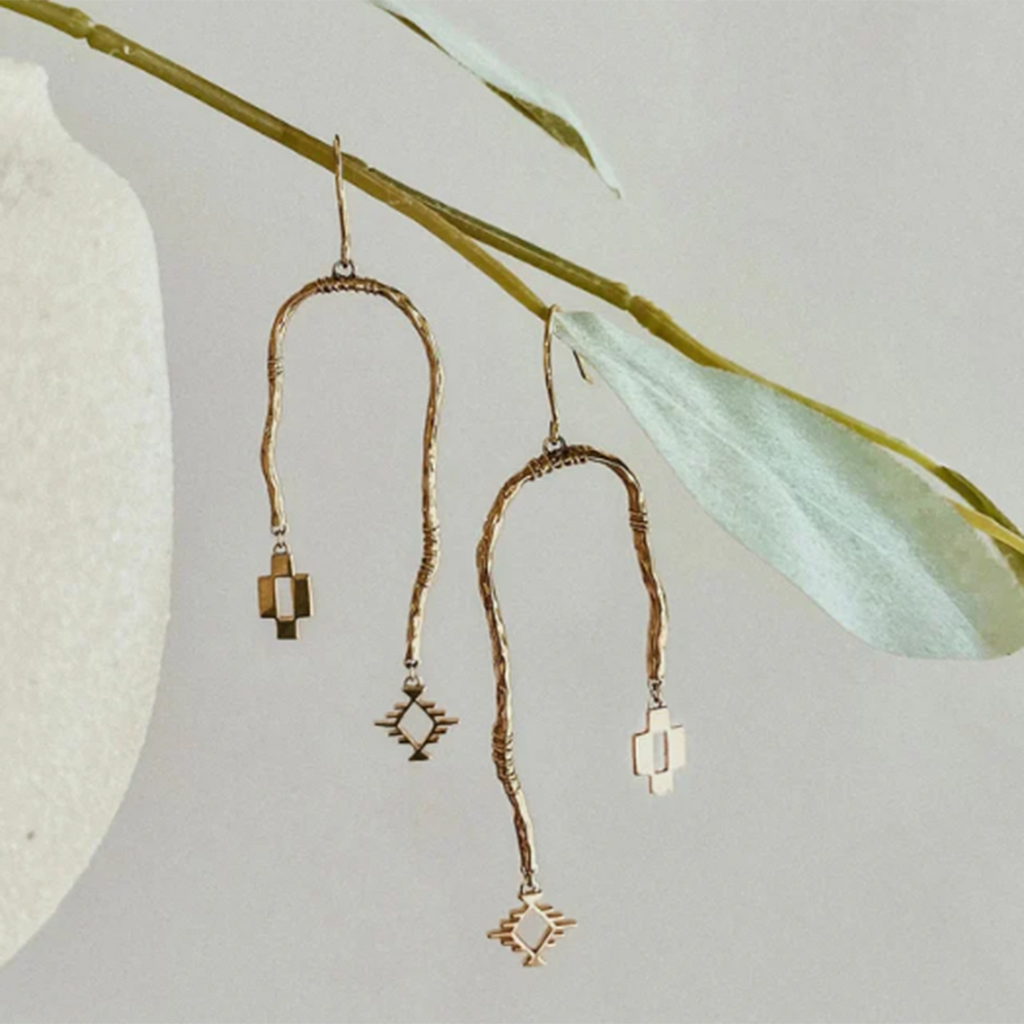 These dangle earrings feature intricate Aztec designs in a gold finish.