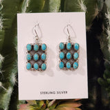 9 turquoise stones set in a square pattern 